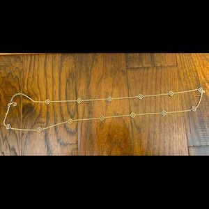 Kendra Scott gold long necklace logo